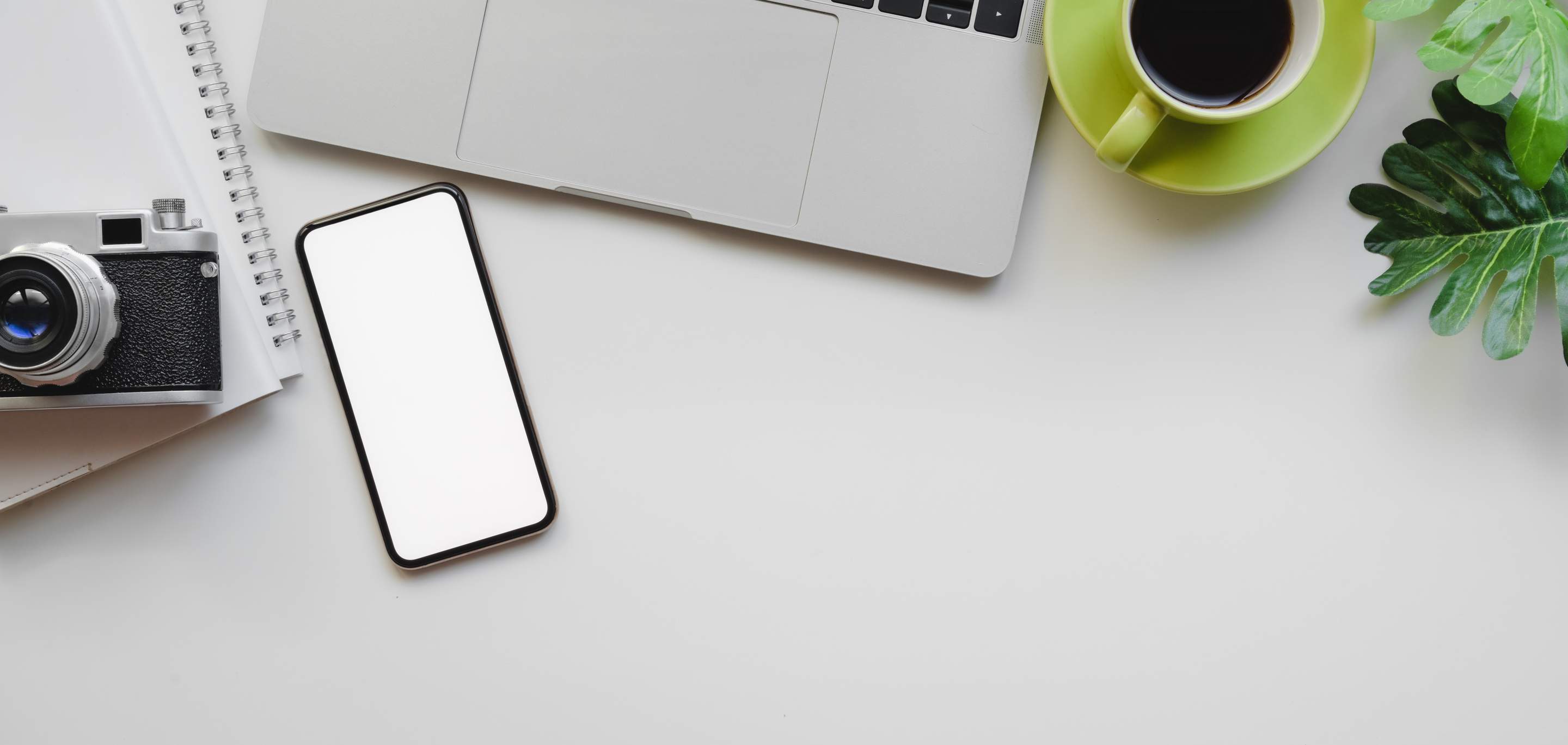 Creative desktop with gadgets and photo camera